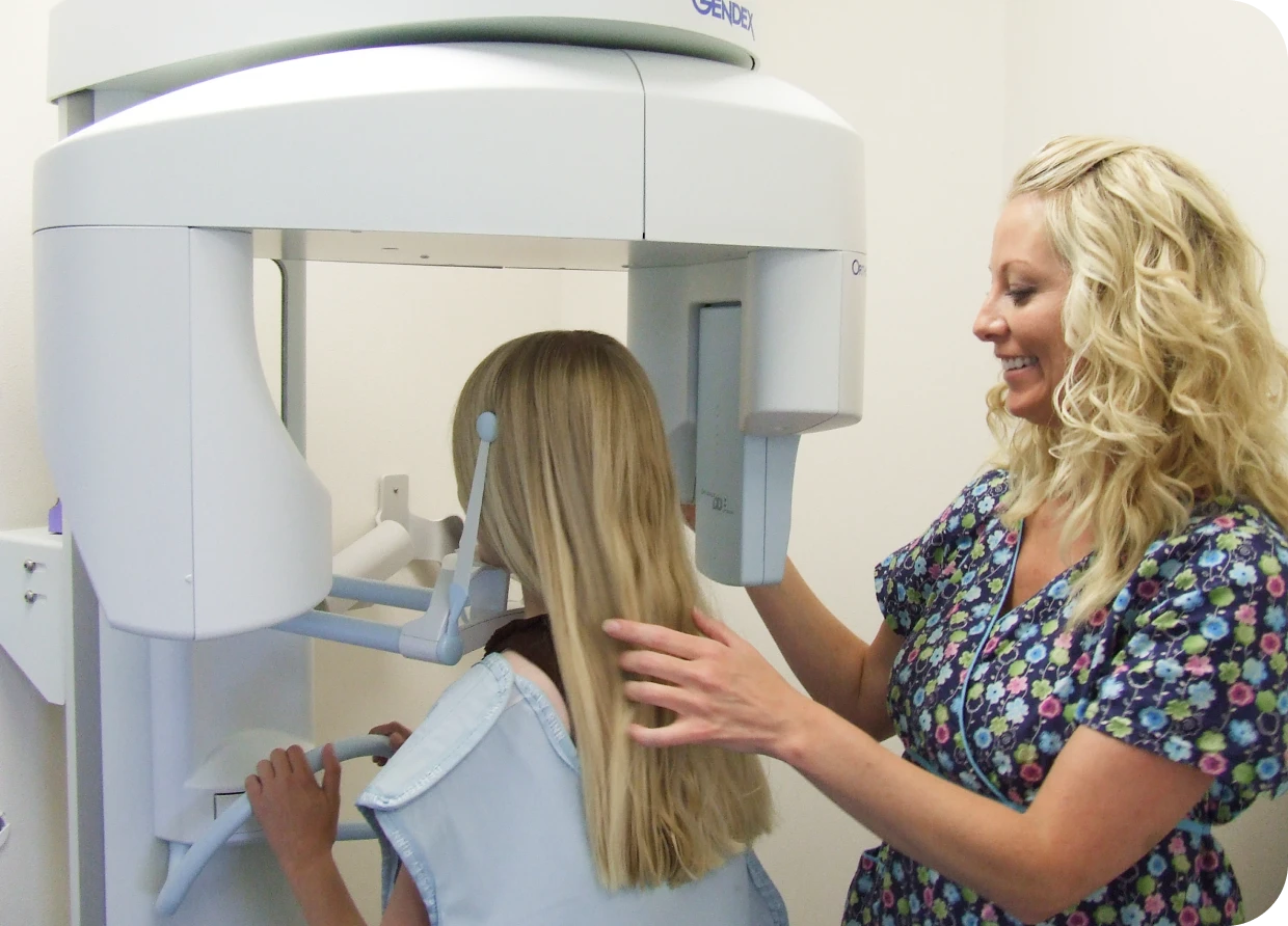 Dental X-ray preparation with assistant guidance.